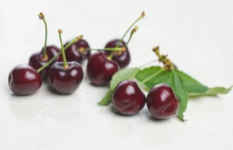 Red cherry on white marble Stock Photos