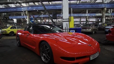 RED CHEVROLET CORVETTE C5. At a car show. Parked in the hangar Stock Footage 207194975