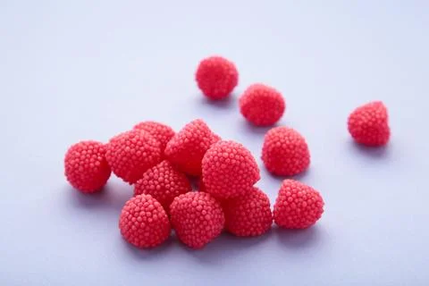 Red chewing sweets in the form of berries. Sweets in the form of raspberries  Stock Photos
