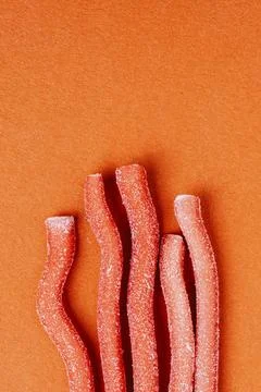 Red chewy candies coated with sugar 2 Stock Photos