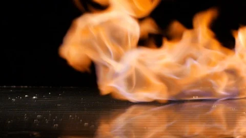 Red chili falling down with flames in the background in slow motion Stock Footage 88808226