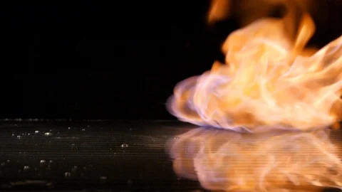 Red chili falling down with flames in the background in slow motion Stock Footage 88808240