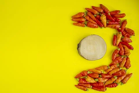 The red chili pattern forms the letter C and there is wood in the middle of t Stock Photos