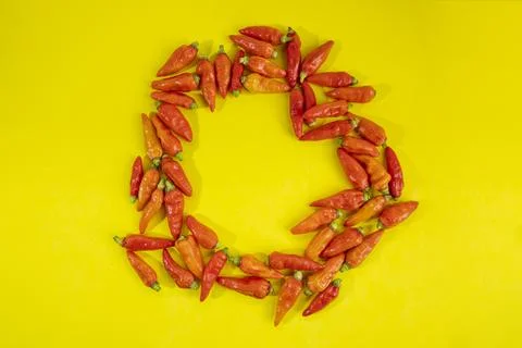 Red chili pattern on a yellow background. Top view. On flat lay. Chili Wallpa Stock Photos