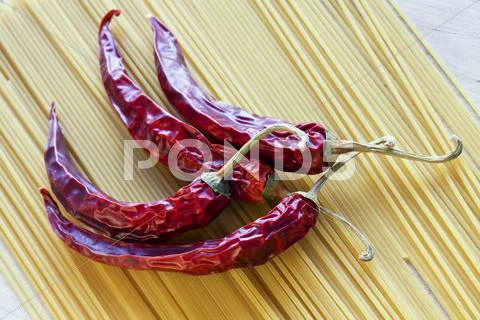 Red chili pepper and spaghetti Stock Photos
