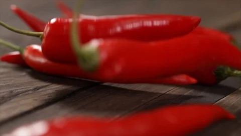 Red Chili Pepper Falling onto other ones Closeup Stock Footage 99138509
