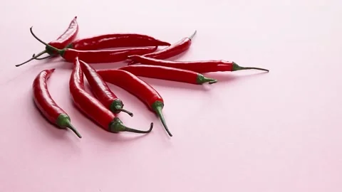 Red chili pepper on pink background Stock Footage 153826448