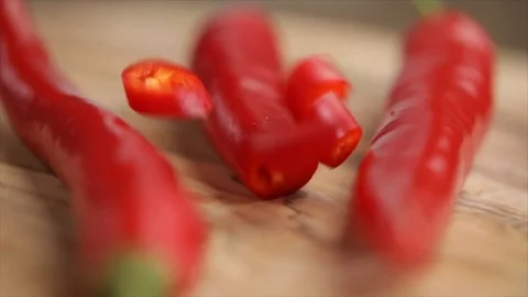 Red Chili Pepper Slices Falling Between whole Peppers Extreme Closeup 動画素材 99138484
