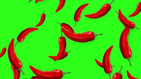 Red Chili Peppers Falling Against a Bright Green Background Stock Footage 342314331