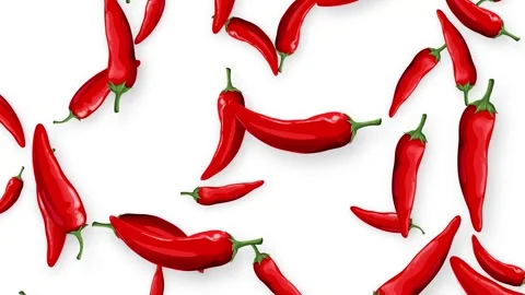 Red Chili Peppers Falling Downward on a Plain White Background Stock Footage 345197749