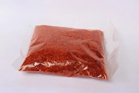 Red chili powder packed inside a transparent plastic packet Stock Photos