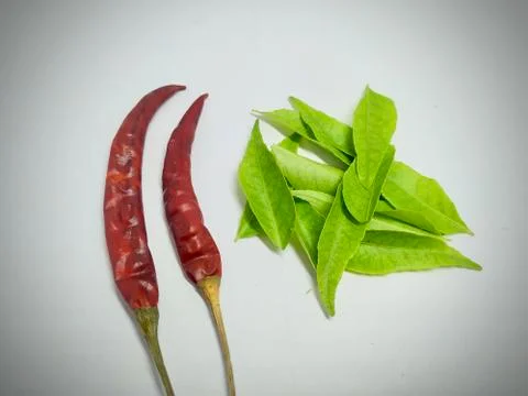 Red chilli, curry leaf On A White Background Stock Stock Photos