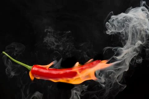 Red chilli with flame, black background, the concept of spicy - pictures Stock Photos