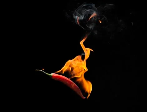 Red chilli with flame, black background, the concept of spicy - pictures Stock Photos