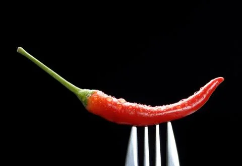 Red chilli on fork Stock Photos