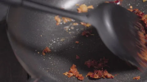 Red chilli paste and garlic get stir-frying on a pan. Macro shot. Stock Footage 147045409