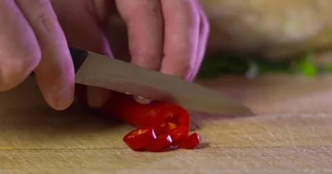 Red chilli pepper chef chops and slices time lapse Video stock 77532716