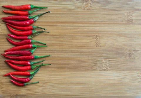Red chilli pepper on Left side of chopping block Stock Photos
