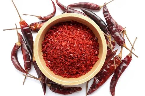 Red Chilli pepper seedless flakes in wooden bowl and Dried red chili pepper Stock Photos