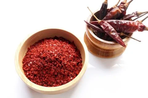 Red chilli pepper seedless flakes in wooden bowl and dried red chili pepper Stock Photos