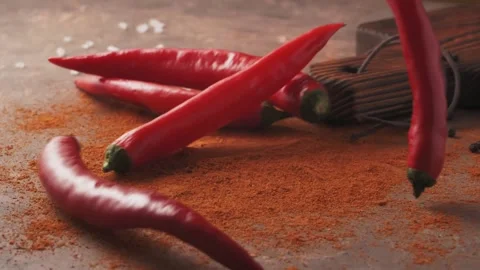 Red chilli peppers Falling down in Exotic Spices. Slow Motion Stock Footage 147861399