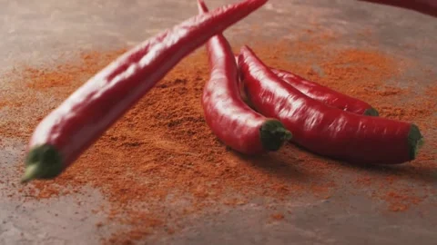 Red chilli peppers Falling down in Exotic Spices. Slow Motion Stock Footage 147861404
