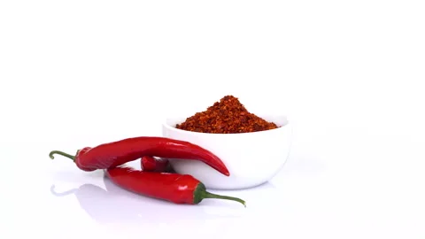 Red chilli peppers turning on white background Stock Footage 171630641