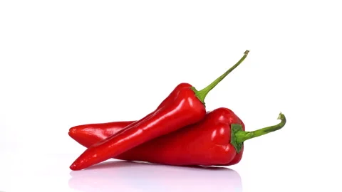Red chilli peppers turning on white background Stock Footage 171630695