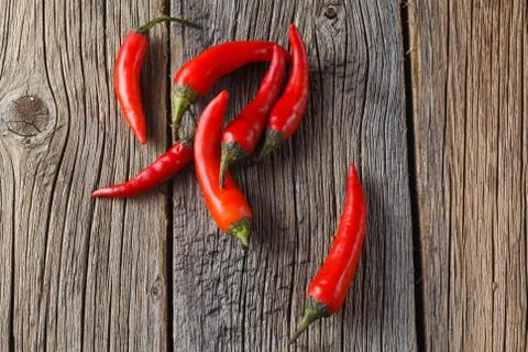 Red chilli on rustic wooden table Stock Photos