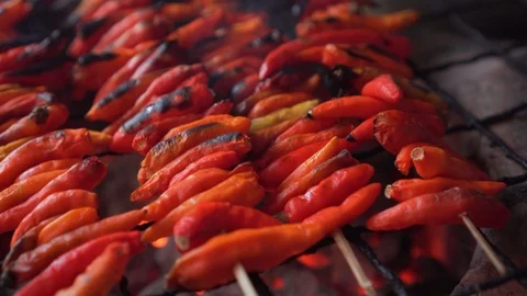 Red chilli with skewer getting grill on a charcoal grill. pick it up with hand Video stock 120023671