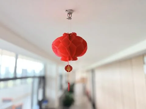 Red Chinese lantern hanging from a ceiling. Stock Photos