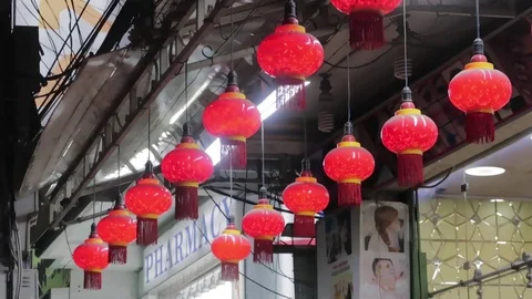 Red Chinese lantern waving in the wind on a black background. 库存影片 119036234