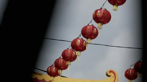 Red Chinese lanterns during Lunar New Year celebration outside temple Stock Footage 134176863