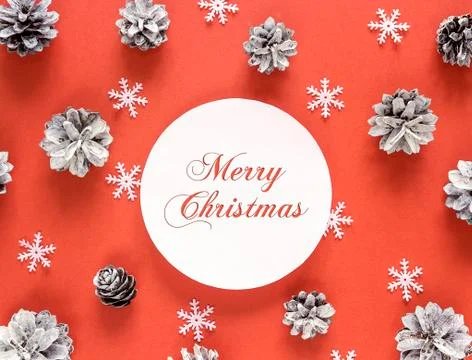 Red Christmas background with congratulation, pine cones and snowflakes. Stock Photos
