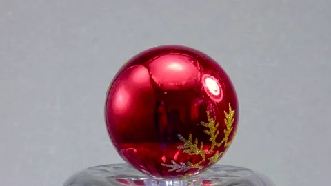 Red Christmas ball with a pattern rotates on a relief surface Stock Footage 160397376