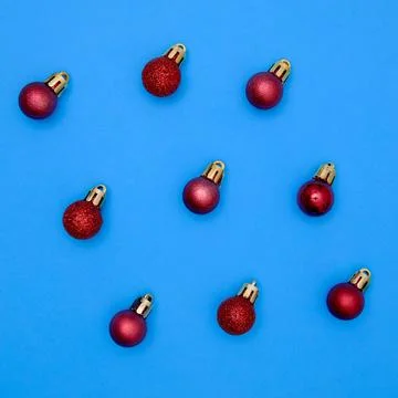 Red christmas ball patterns on solid blue background. Balls of different text Stock Photos