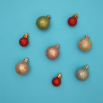 Red christmas ball patterns on solid blue background. Balls of different text Stock Photos
