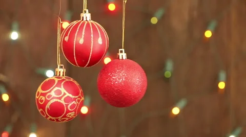 Red Christmas balls hanging on strings. Flashing a garland blurred background Stock Footage 66354158