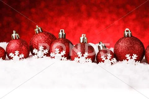 Red christmas balls on snow Stock Photos