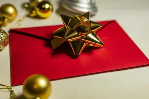 Red Christmas Envelope With Gold Bow and Baubles Stock Photos