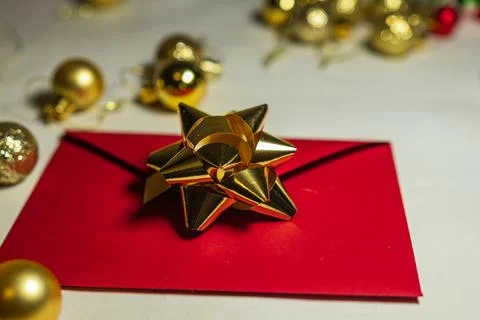 Red Christmas Envelope With Gold Bow and Baubles Stock Photos