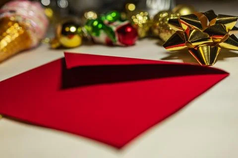 Red Christmas Envelope With Gold Bow And Ornaments Stock Photos