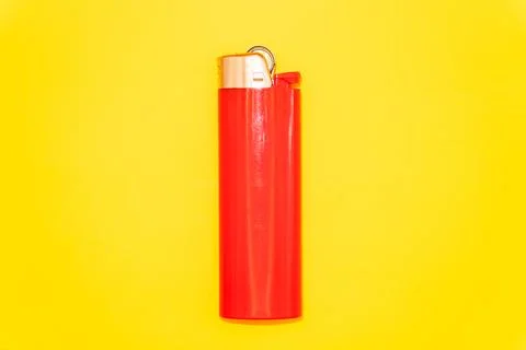Red cigarette lighter on yellow background, no smoking day, quit smoking, Stock Photos