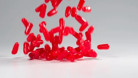 Red cinnamon candies fall in slow motion Stockbeeldmateriaal 117467307
