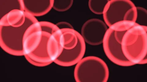 Red circles moving across a dark background with soft glow Stock Footage 338018179