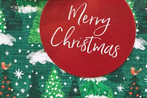 Red Circular Gift Tag on Christmas-Themed Wrapping Paper Stock Illustration
