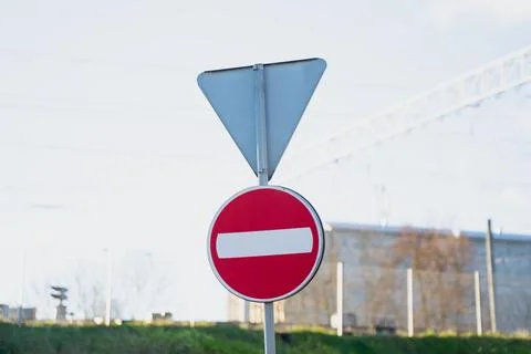 Red circular no entry symbol mounted on post with unused triangular frame Stock Photos