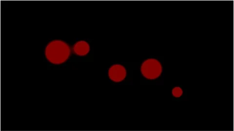 Red circular particles move randomly on a black background Stock Footage 346759280