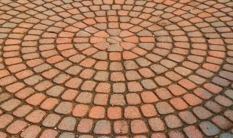Red circular paved bricks with dirty moss Stock Photos
