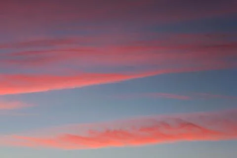 Red cirrus clouds at sunset. Stock Photos